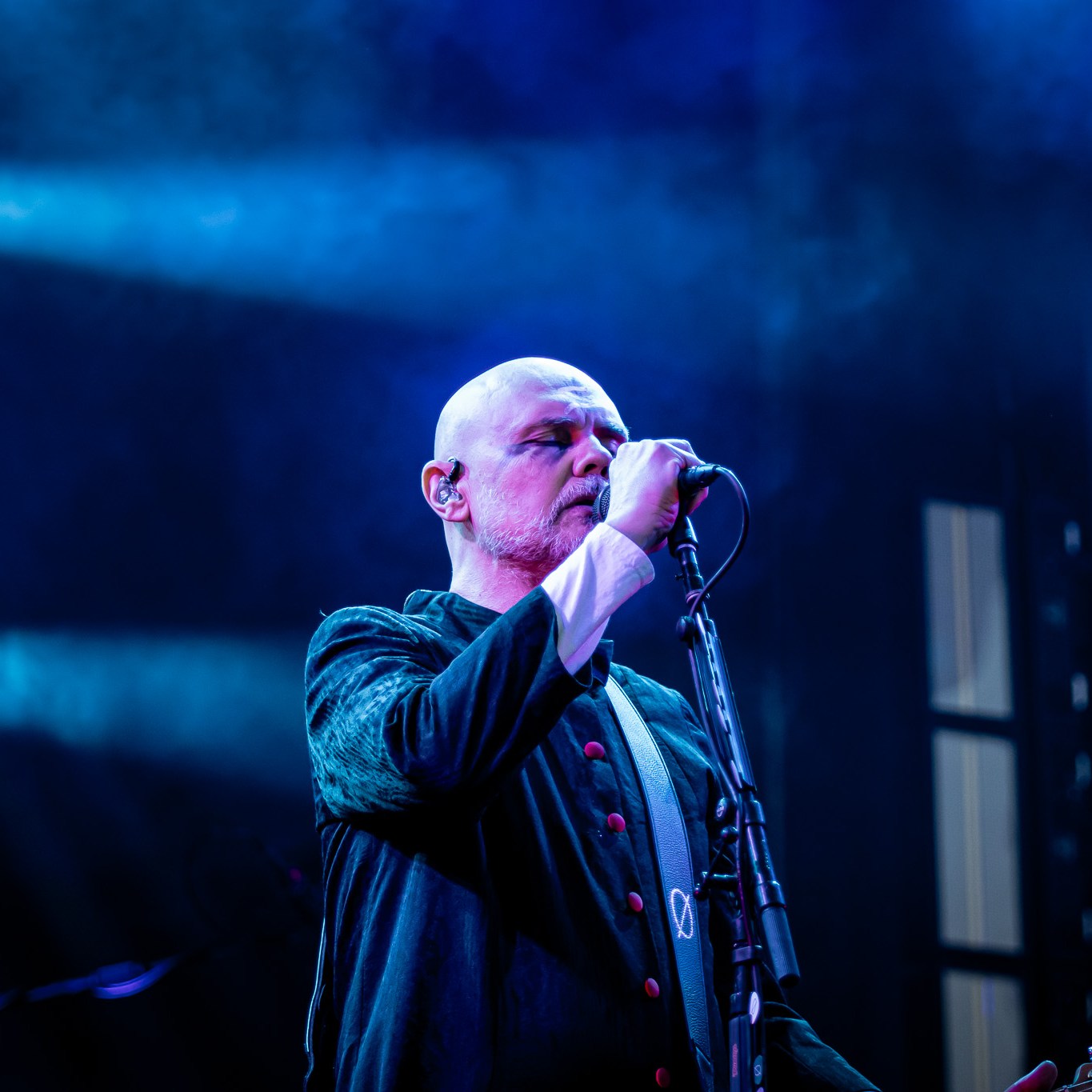 Billy Corgan of The Smashing Pumpkins on stage in a black cloak