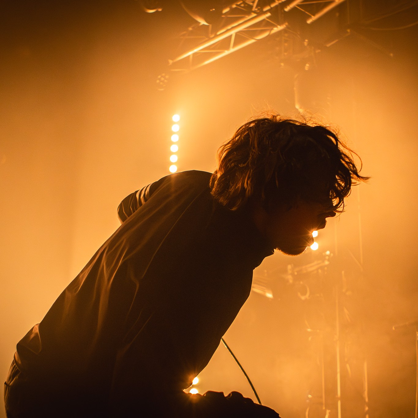 Chalk's band lead vocalist's silhouette against orange light