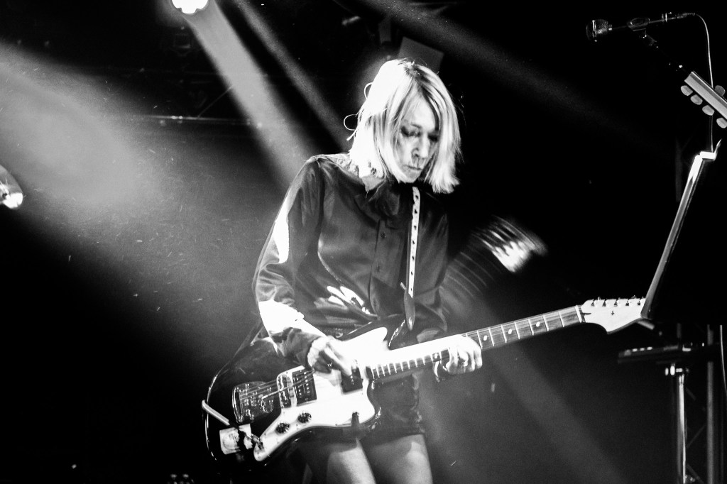 Kim Gordon performing on stage at Den Atelier, Luxembourg