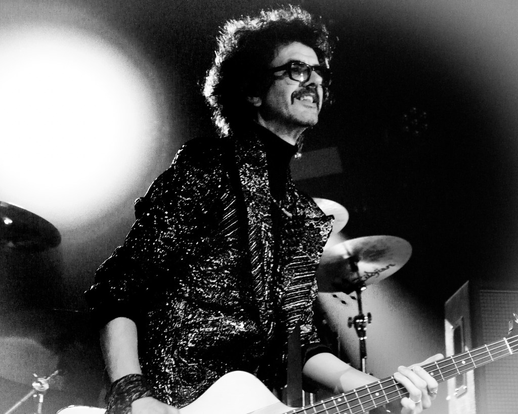 Bassist Frankie Poullain smiling on stage